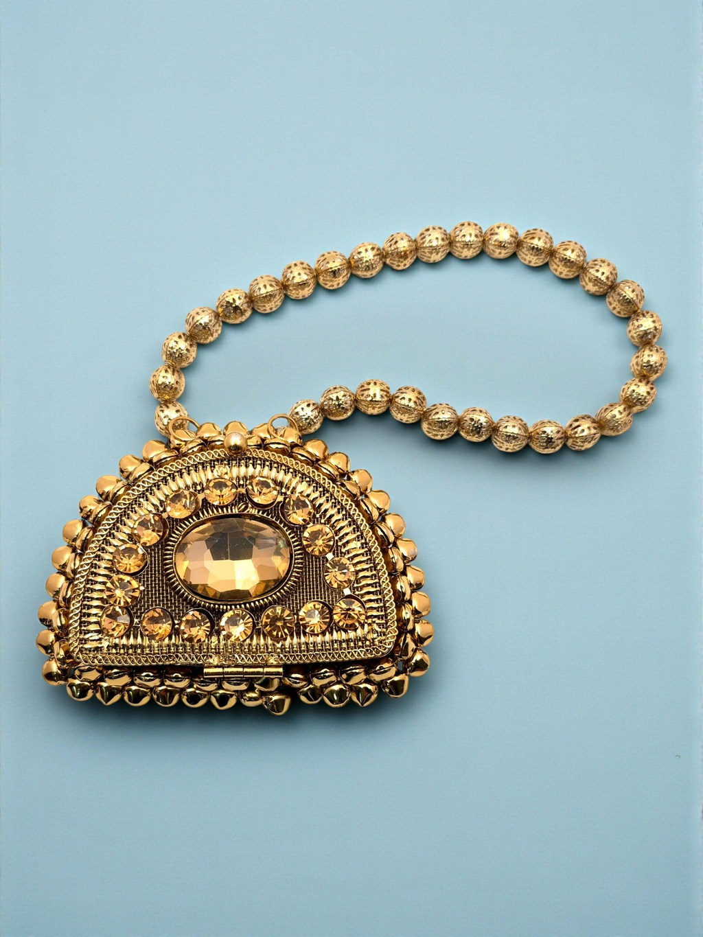 ThreadItStudio Maharani Chaand golden metal clutch with ornate crystal detailing and a beaded handle for ethnic wear.