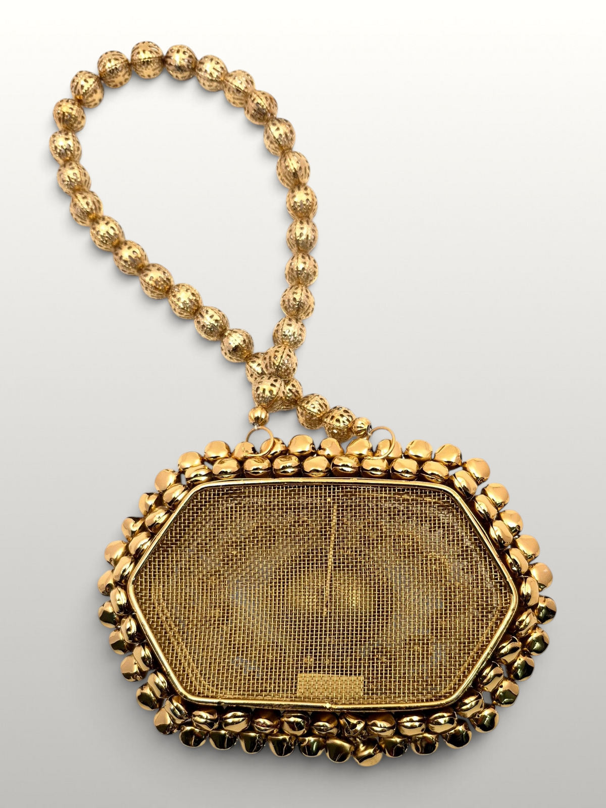 ThreadItStudio Maharani metal batua bag with gold mesh, evil eye motif, and a decorative beaded handle.