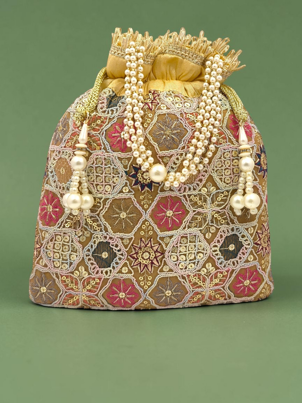 ThreadItStudio peach and golden potli bag with intricate geometric zari embroidery and elegant pearl tassel accents.