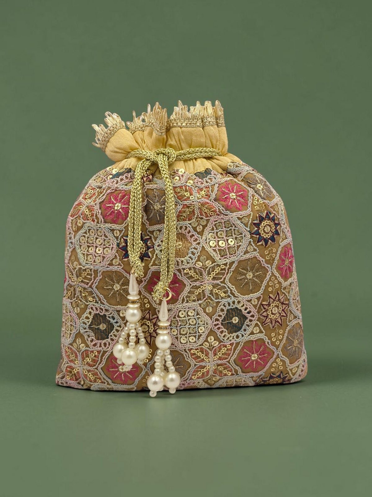 ThreadItStudio peach and golden potli bag with intricate geometric zari embroidery and hanging pearl tassels.