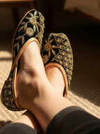 ThreadItStudio handcrafted midnight black jutti with intricate gold floral embroidery for festive occasions