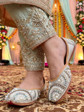 ThreadItStudio silver base jutti featuring intricate multi-color kundan stone and pearl embellishments for bridal wear