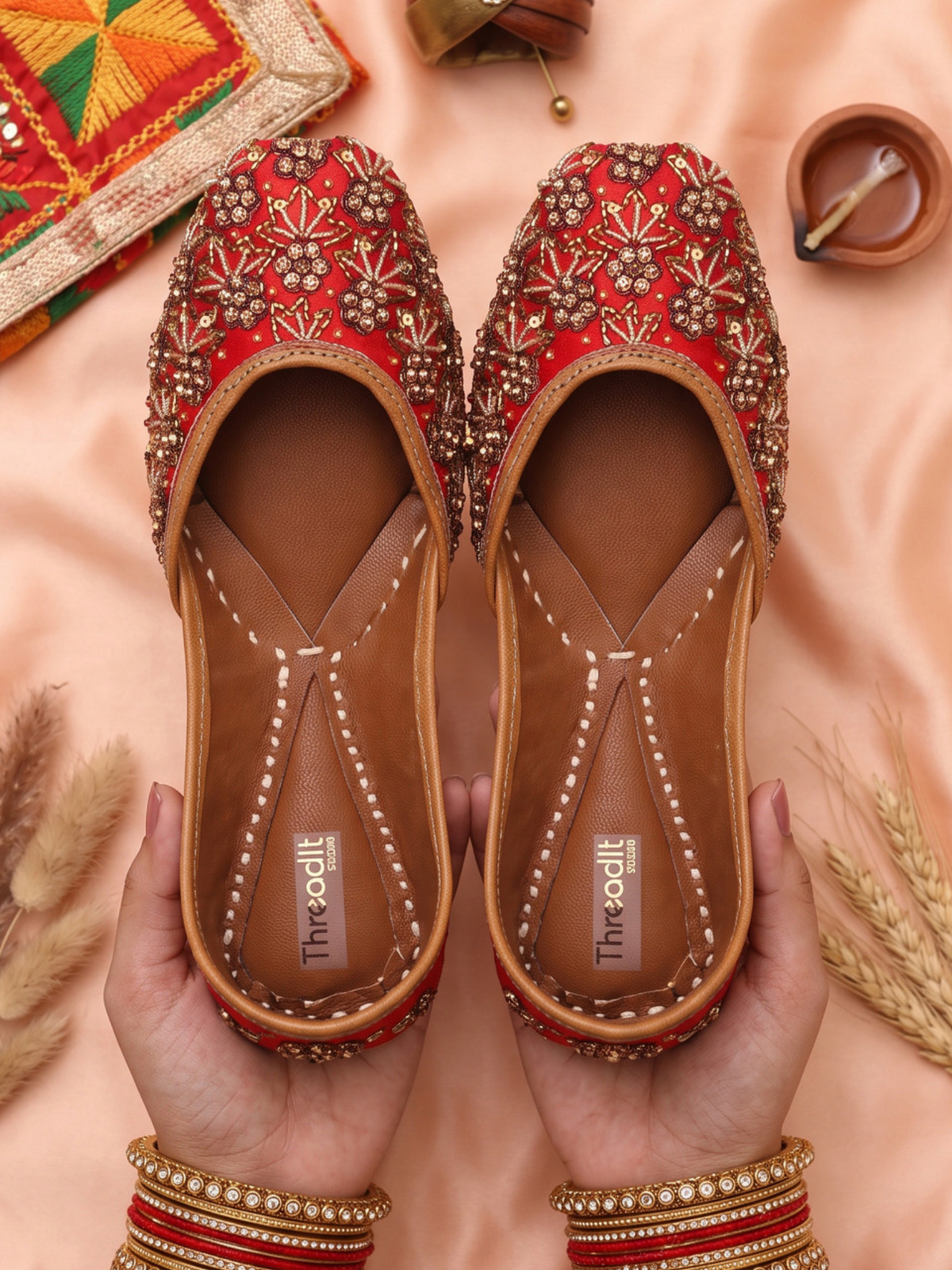 ThreadItStudio red and golden jutti with heavy dabka handwork embroidery worn with blue embroidered trousers