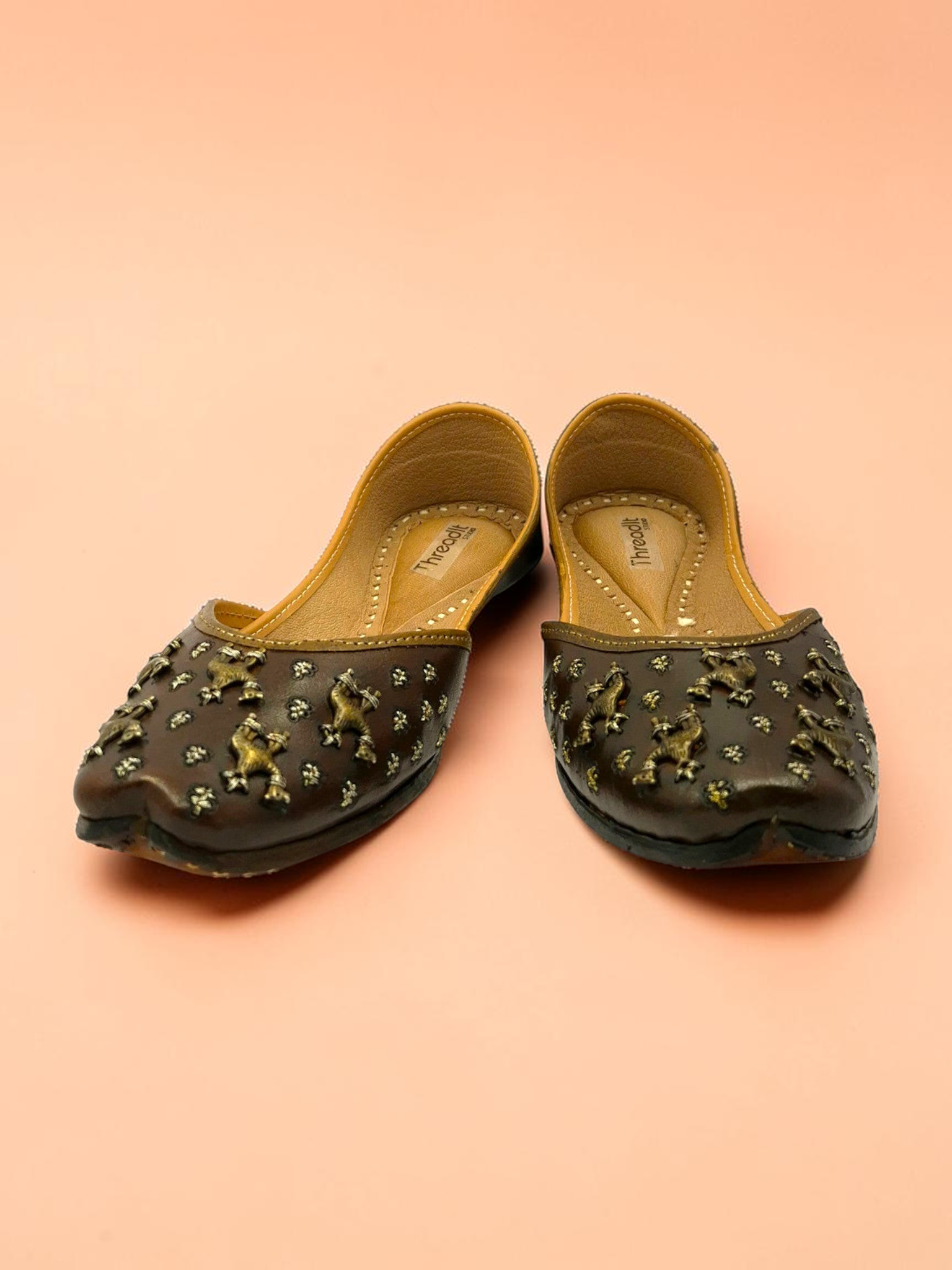 ThreadItStudio brown leather juttis with antique brass camel motifs and metallic studs for festive wear