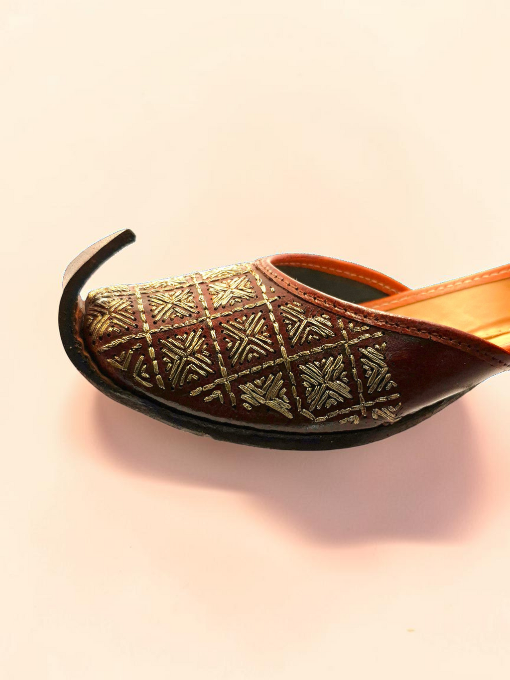 ThreadItStudio brown leather jutti with gold-thread grid embroidery and a classic curved toe design.