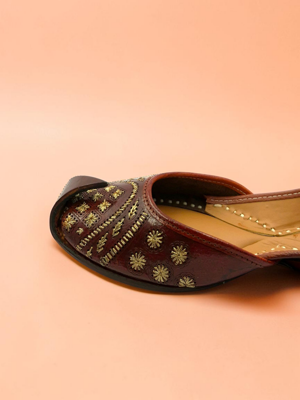 ThreadItStudio Heer Steps brown leather jutti with intricate gold floral embroidery and traditional curved toe design.