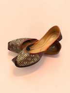 ThreadItStudio brown leather juttis with gold-thread grid embroidery and traditional curved toe design.