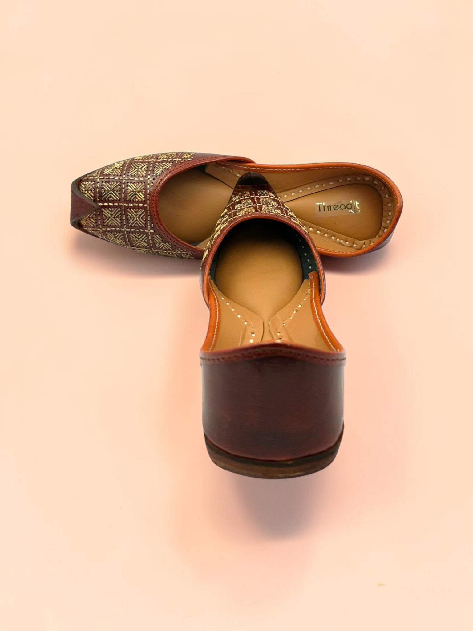 ThreadItStudio Rang Punjab brown leather juttis with intricate gold-thread grid embroidery and classic curved toe