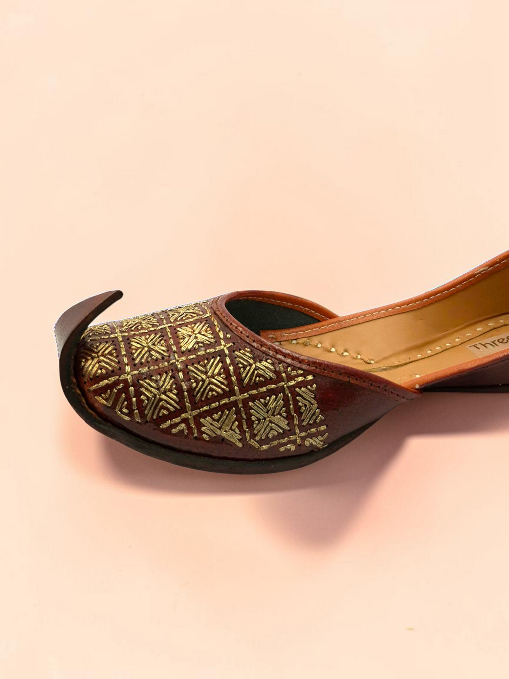ThreadItStudio Rang Punjab brown leather juttis with intricate gold-thread grid embroidery and classic curved toe.