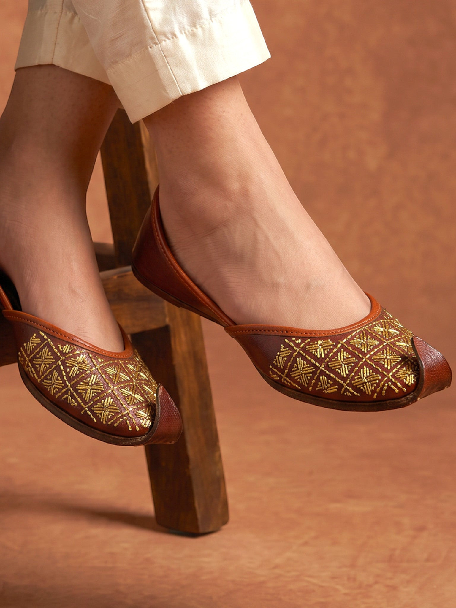 ThreadItStudio Rang Punjab brown leather juttis with intricate gold-thread grid embroidery and classic curved toe