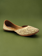 ThreadItStudio handcrafted jutti with intricate golden embroidery and beadwork on a cream base for festive wear.