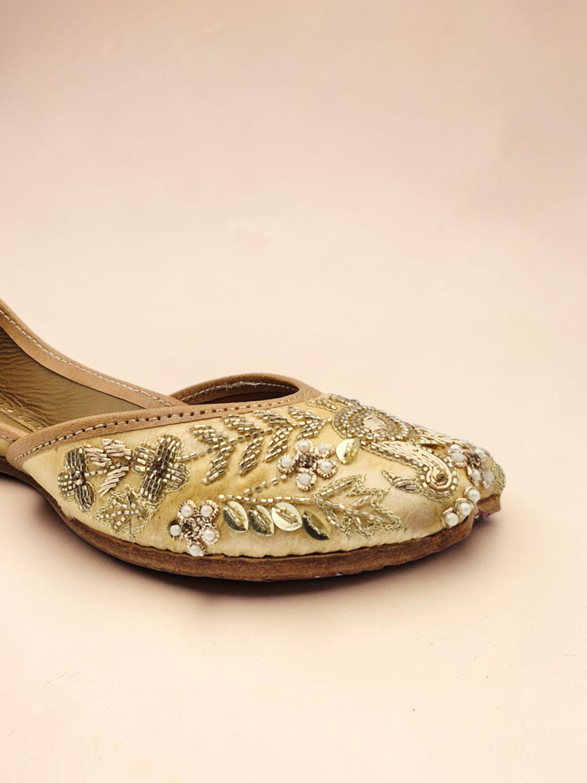 ThreadItStudio handcrafted golden jutti with intricate metallic embroidery and beadwork for festive occasions