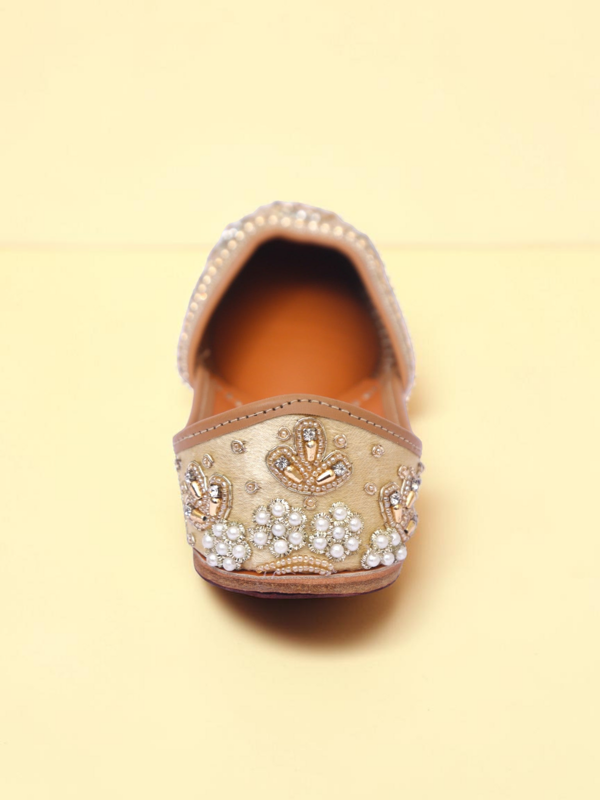 ThreadItStudio golden jutti featuring intricate pearl and bead embroidery on a traditional handcrafted silhouette