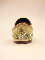 ThreadItStudio handcrafted golden jutti with intricate peacock embroidery, beads, and sequins for festive wear.