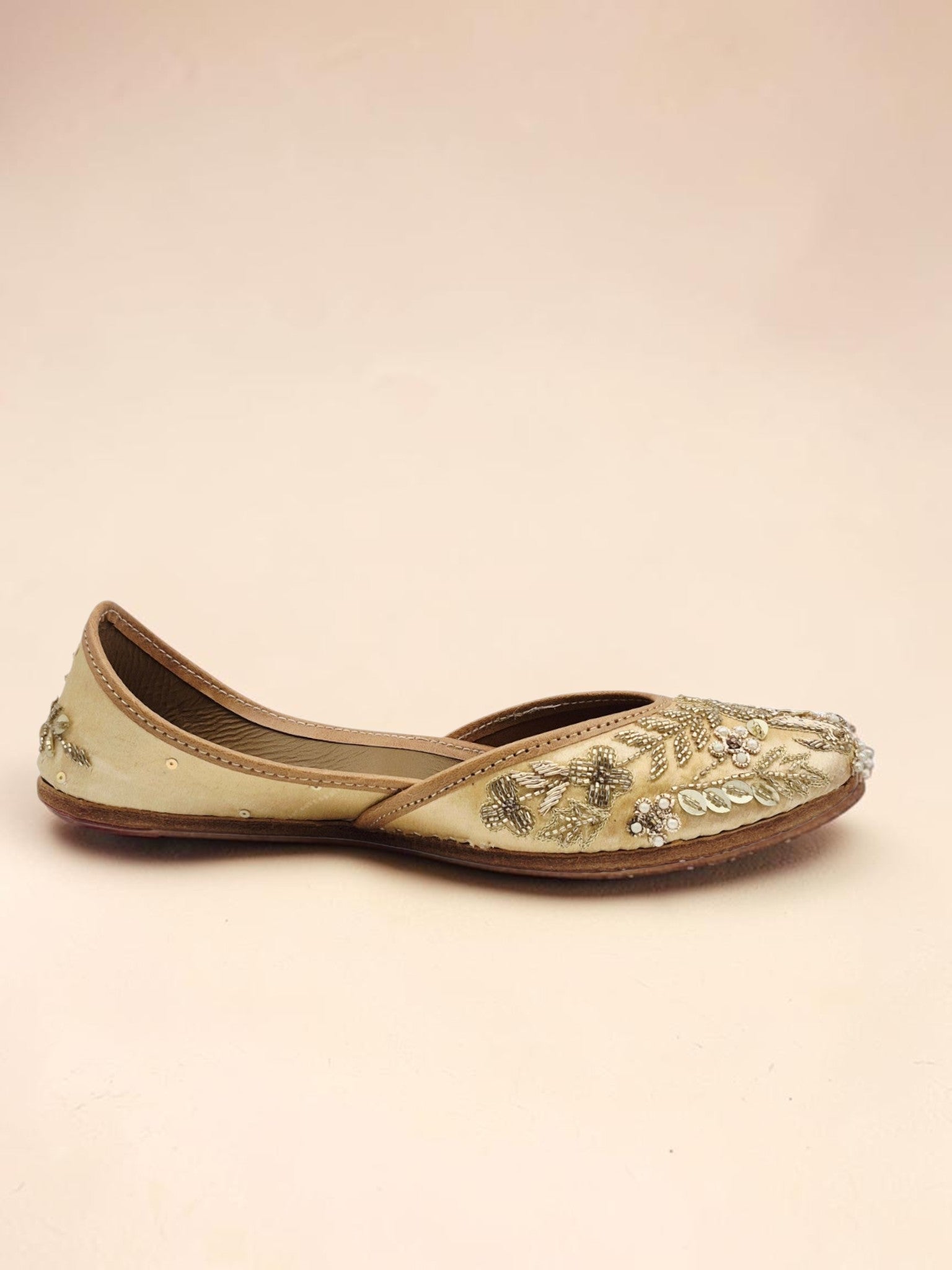 ThreadItStudio handcrafted golden jutti with intricate peacock embroidery and beadwork for festive occasions