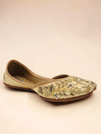 ThreadItStudio handcrafted golden jutti with intricate peacock embroidery and traditional beadwork for festive wear.