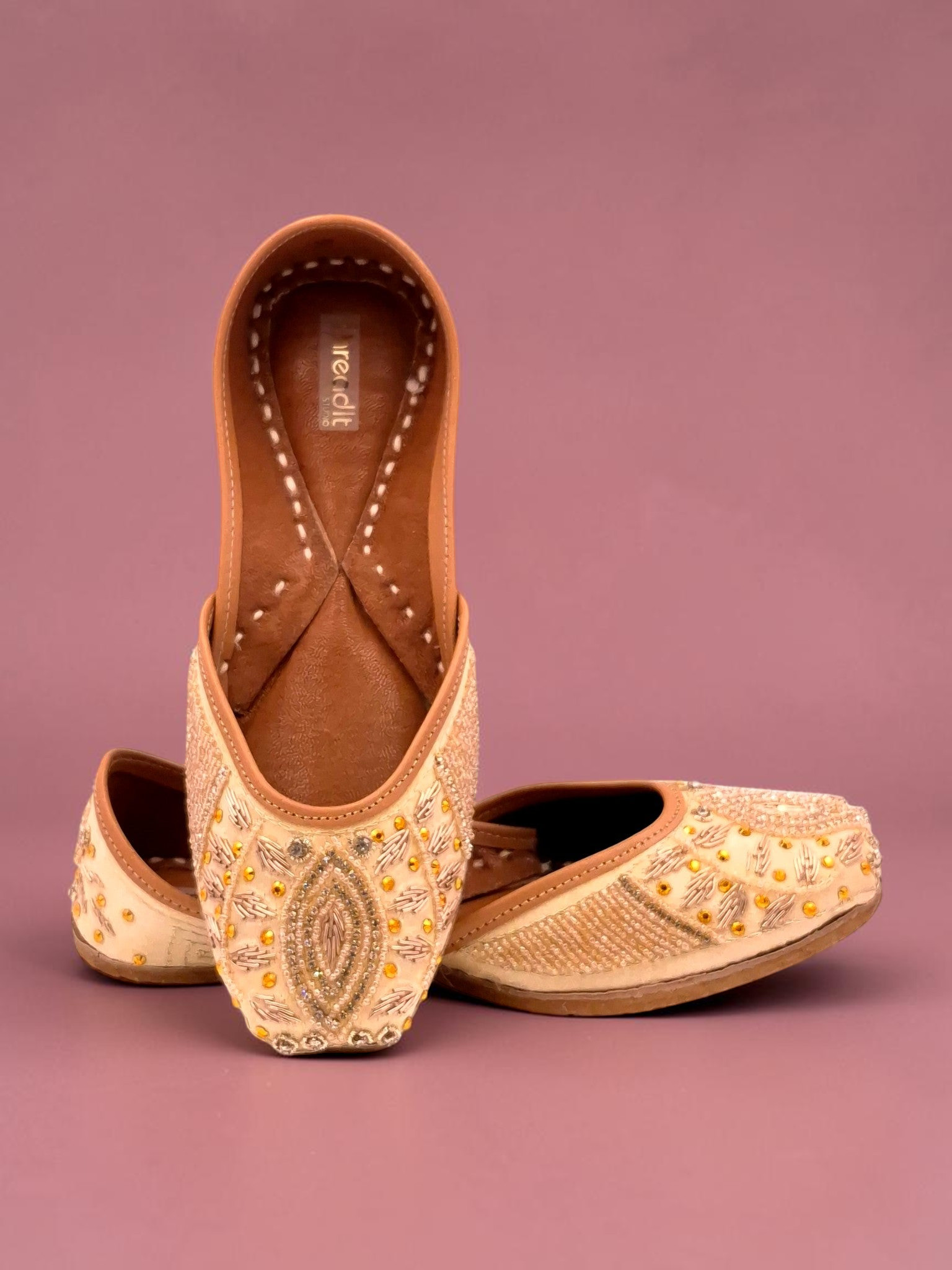 ThreadItStudio Honey Glow Steps artisanal juttis with intricate gold embroidery and beadwork on cream fabric