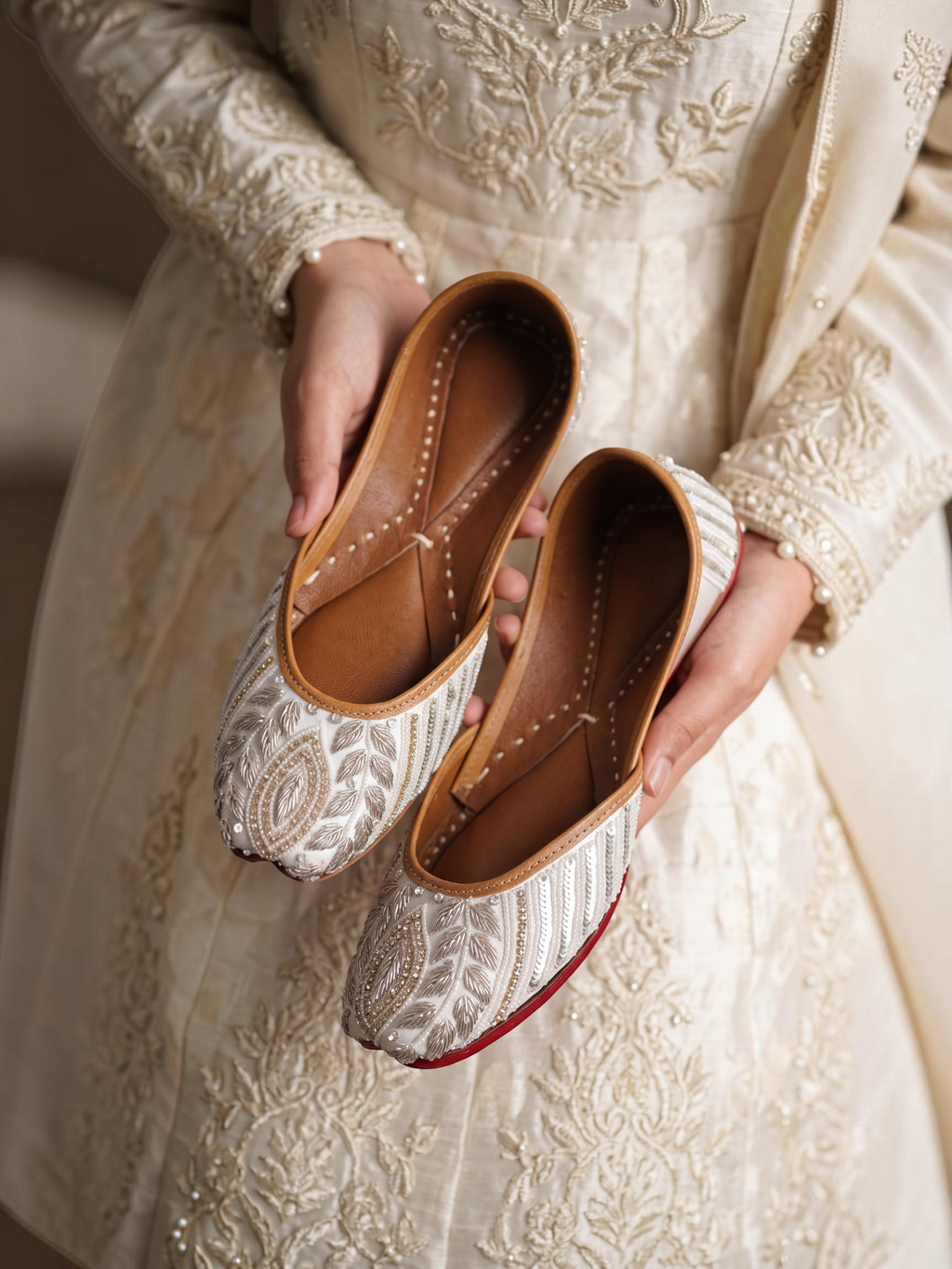 ThreadItStudio ivory juttis featuring delicate petal embroidery and intricate floral needlework on handcrafted fabric.
