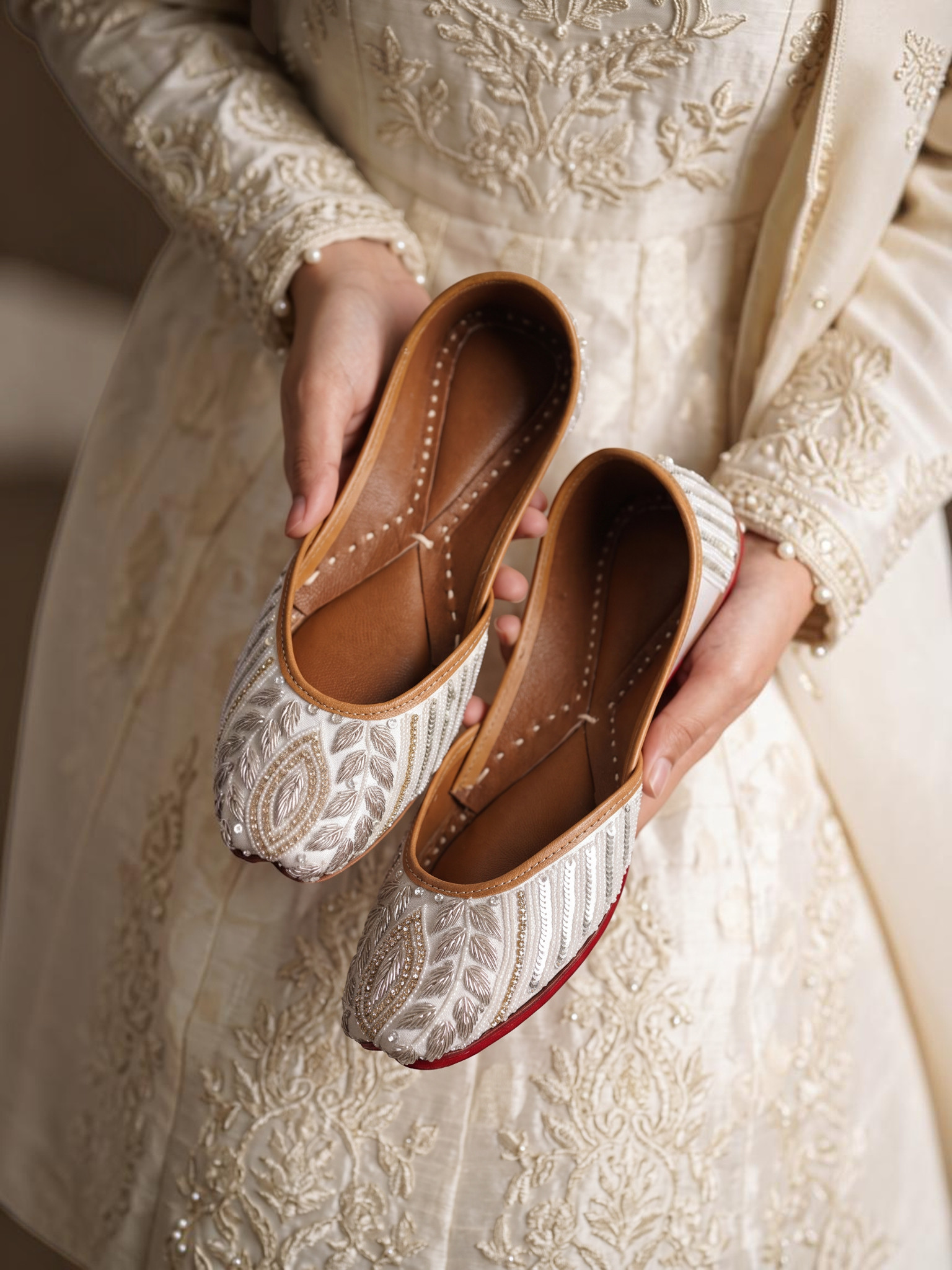 ThreadItStudio ivory juttis featuring delicate petal embroidery and intricate floral needlework on handcrafted fabric.
