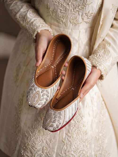 ThreadItStudio ivory juttis featuring delicate petal embroidery and intricate floral needlework on handcrafted fabric.
