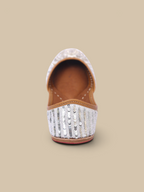 ThreadItStudio Ivory Virasat handcrafted juttis featuring intricate silver sequin embroidery and floral detailing.