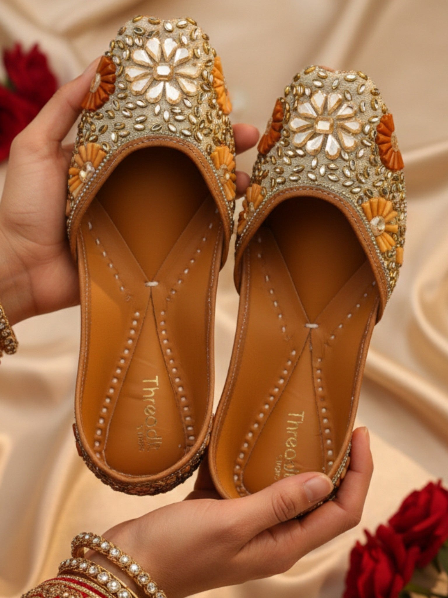 ThreadItStudio handcrafted ethnic jutti featuring intricate gold kundan beadwork and floral patterns for festive wear.