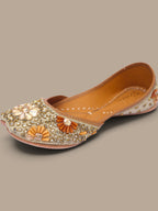 ThreadItStudio handcrafted ethnic jutti featuring intricate gold and orange kundan beadwork for festive occasions.