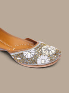 ThreadItStudio handcrafted ethnic jutti featuring intricate white and gold kundan beadwork on a beige base.