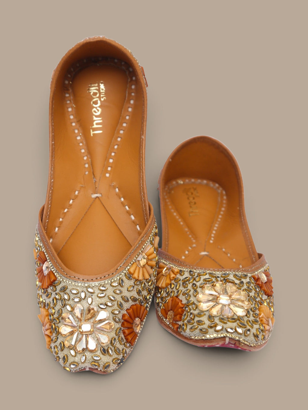 ThreadItStudio handcrafted ethnic jutti featuring intricate gold kundan beadwork and floral embellishments