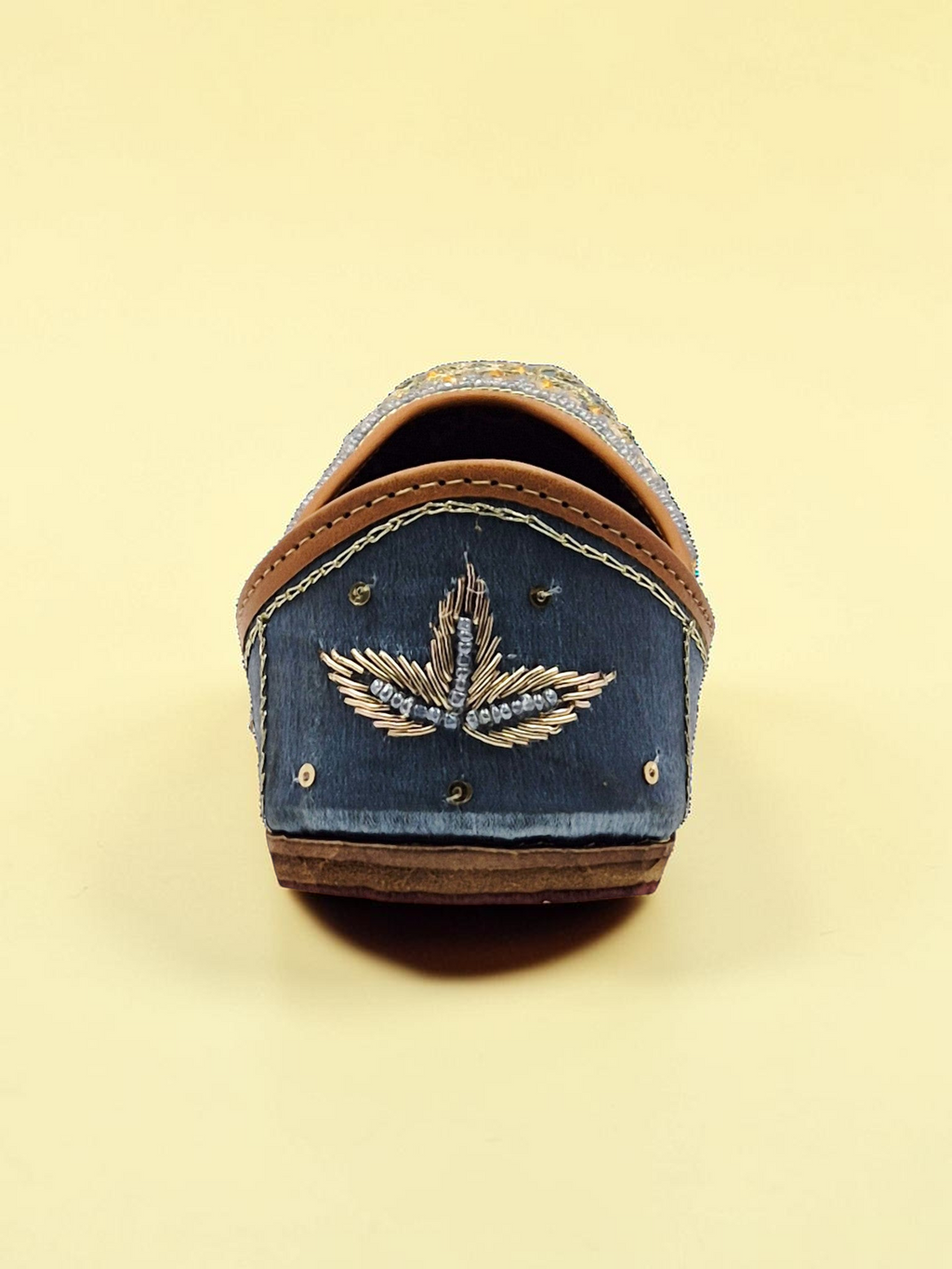 ThreadItStudio midnight blue handcrafted jutti with intricate gold eagle embroidery and traditional artisanal details.