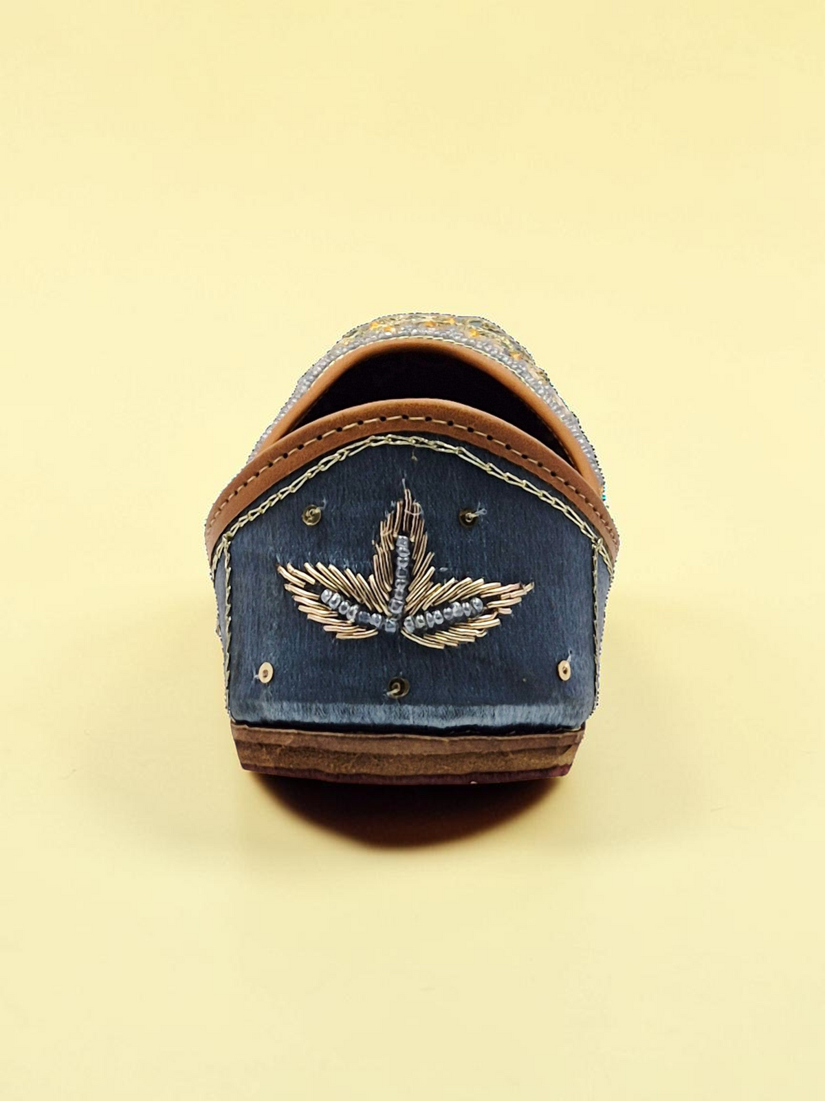 ThreadItStudio midnight blue handcrafted jutti with intricate gold eagle embroidery and traditional artisanal details.