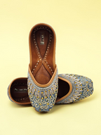 ThreadItStudio handcrafted midnight blue jutti with intricate gold eagle embroidery and traditional artisanal details.