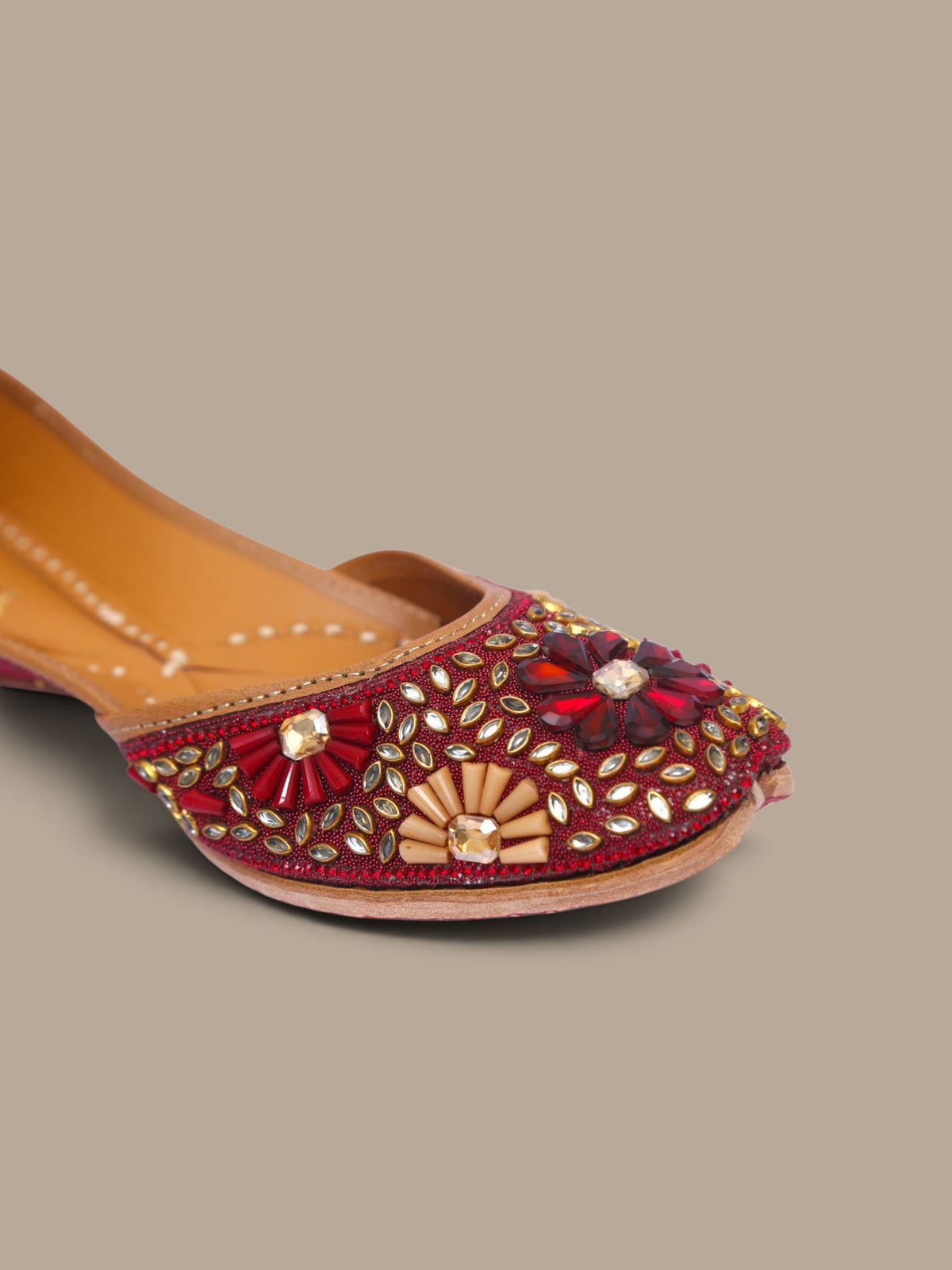 ThreadItStudio handcrafted red ethnic jutti featuring intricate kundan beadwork and floral embellishments for weddings.
