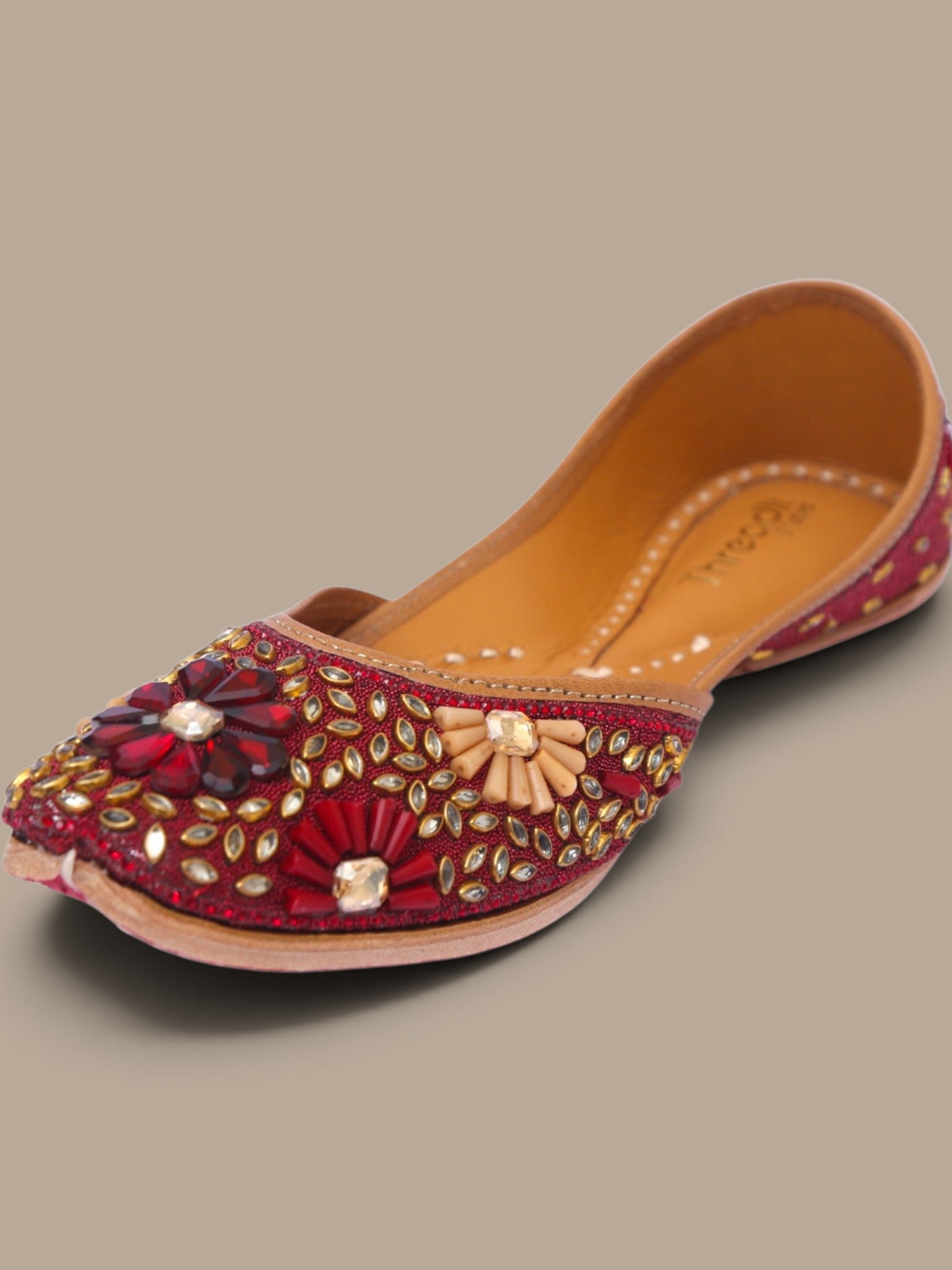ThreadItStudio handcrafted red ethnic jutti featuring intricate kundan beadwork and floral embellishments for weddings.