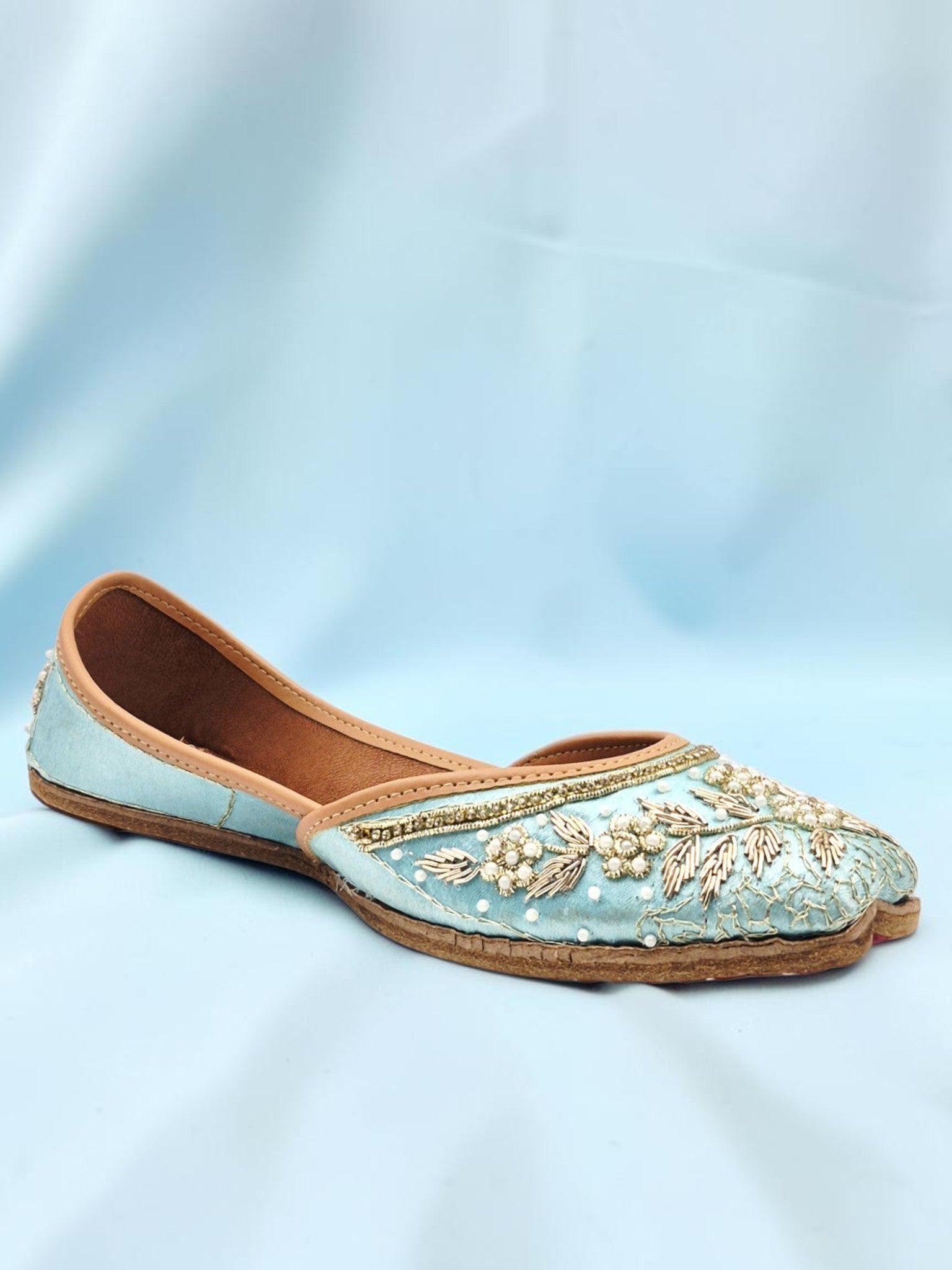 ThreadItStudio handcrafted sky blue ethnic jutti with intricate gold embroidery and beadwork for festive wear.