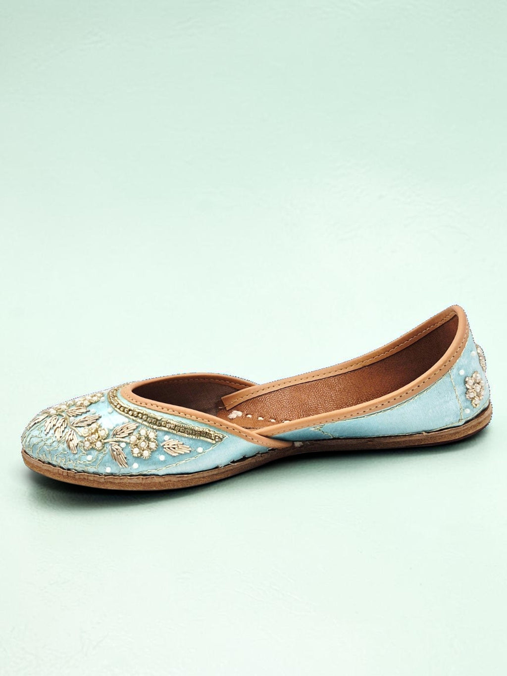 ThreadItStudio handcrafted sky blue ethnic jutti with intricate gold floral embroidery and traditional detailing.