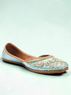 ThreadItStudio handcrafted sky blue ethnic jutti with intricate gold embroidery and pearl detailing on a light background
