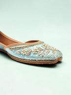 ThreadItStudio handcrafted sky blue ethnic jutti with intricate gold embroidery and pearl detailing on a soft fabric