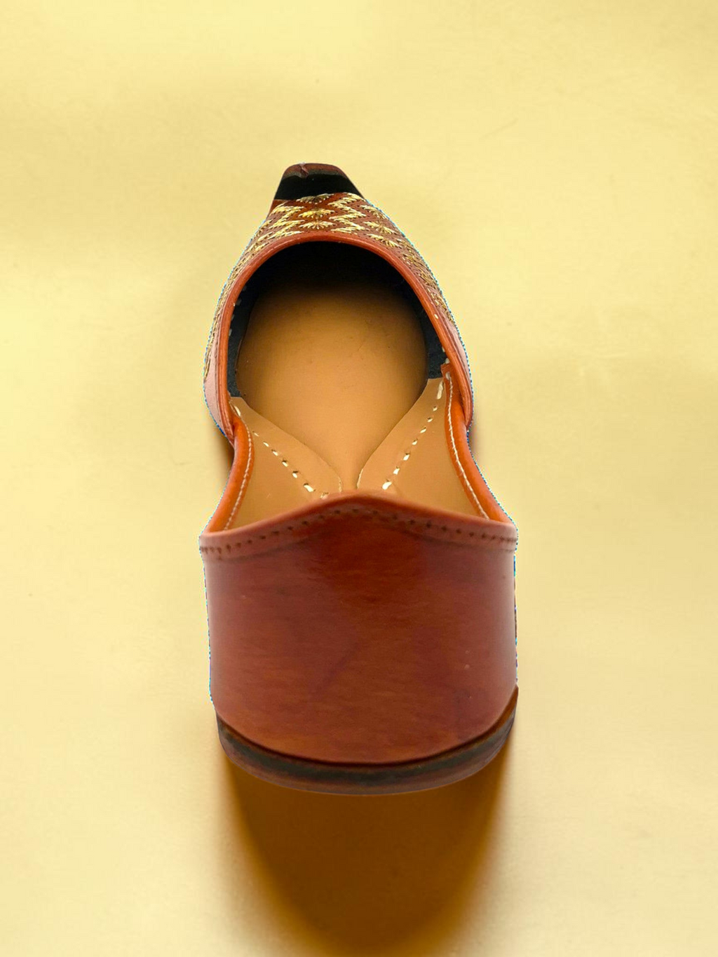 ThreadItStudio tan-brown leather jutti with gold-thread geometric embroidery and a classic curved toe box.