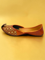 ThreadItStudio Virsa Walk tan leather jutti with gold geometric and floral embroidery on a gold background